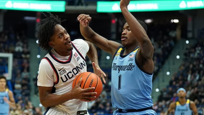 Feb 7, 2023; Hartford, Connecticut, USA; UConn Huskies guard Tristen Newton (2) drives the ball against Marquette Golden Eagles guard Kam Jones (1) in the first half at XL Center. Mandatory Credit: David Butler II-USA TODAY Sports