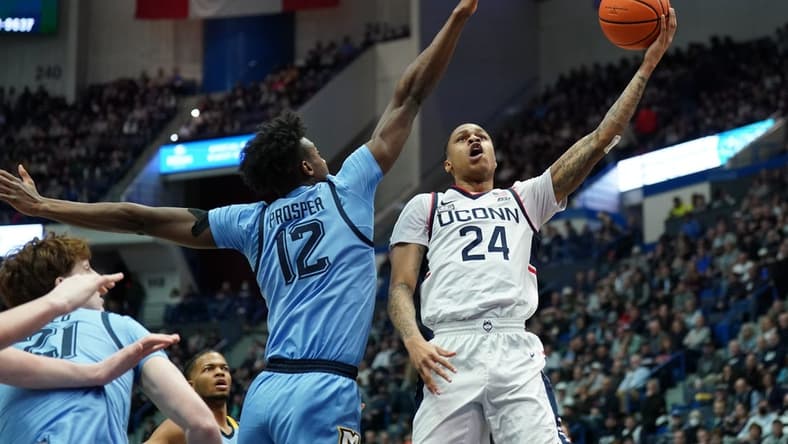 Feb 7, 2023; Hartford, Connecticut, USA; UConn Huskies guard Jordan Hawkins (24) shoots against Marquette Golden Eagles forward Olivier-Maxence Prosper (12) in the first half at XL Center. Mandatory Credit: David Butler II-USA TODAY Sports
