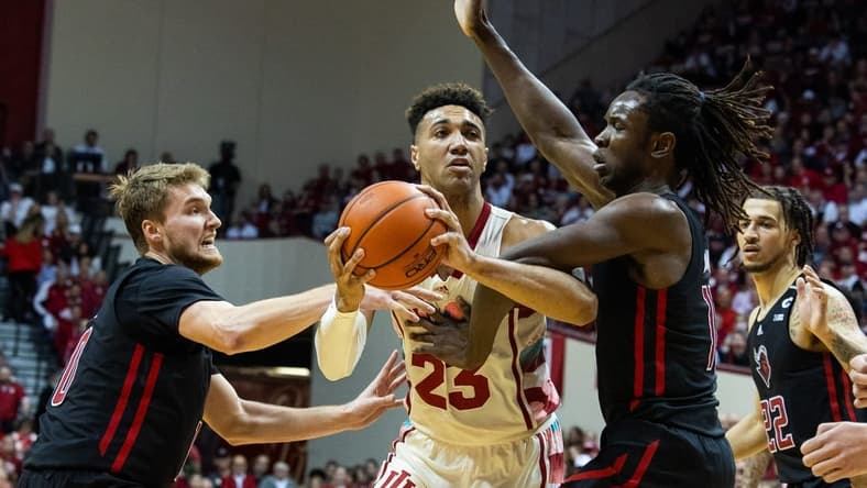 Feb 7, 2023; Bloomington, Indiana, USA; Indiana Hoosiers forward Trayce Jackson-Davis (23) shoots the ball while Rutgers Scarlet Knights guard Cam Spencer (10) and center Clifford Omoruyi (11) defend in the first half at Simon Skjodt Assembly Hall. Mandatory Credit: Trevor Ruszkowski-USA TODAY Sports