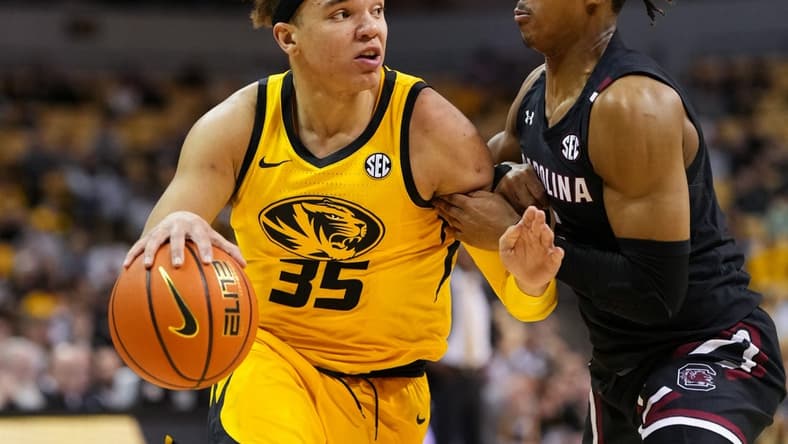 Feb 7, 2023; Columbia, Missouri, USA; Missouri Tigers forward Noah Carter (35) drives against South Carolina Gamecocks guard Meechie Johnson (5) during the first half at Mizzou Arena. Mandatory Credit: Jay Biggerstaff-USA TODAY Sports