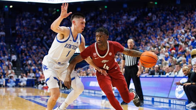 Feb 7, 2023; Lexington, Kentucky, USA; Arkansas Razorbacks guard Davonte Davis (4) drives to the basket around Kentucky Wildcats guard CJ Fredrick (1) during the first half at Rupp Arena at Central Bank Center. Mandatory Credit: Jordan Prather-USA TODAY Sports