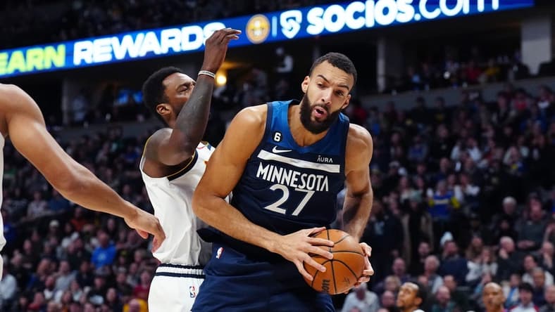 Feb 7, 2023; Denver, Colorado, USA; Minnesota Timberwolves center Rudy Gobert (27) pulls a rebound in away from Denver Nuggets forward Jeff Green (32) in the second quarter at Ball Arena. Mandatory Credit: Ron Chenoy-USA TODAY Sports