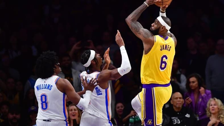 Feb 7, 2023; Los Angeles, California, USA; Los Angeles Lakers forward LeBron James (6) shoots against Oklahoma City Thunder guard Shai Gilgeous-Alexander (2) in the first quarter at Crypto.com Arena. Mandatory Credit: Gary A. Vasquez-USA TODAY Sports