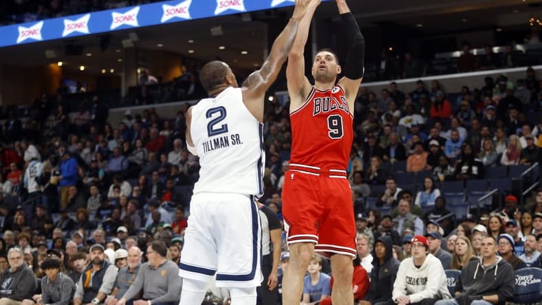 Feb 7, 2023; Memphis, Tennessee, USA; Chicago Bulls center Nikola Vucevic (9) shoots as Memphis Grizzlies forward Xavier Tillman (2) defends during the second half at FedExForum. Mandatory Credit: Petre Thomas-USA TODAY Sports