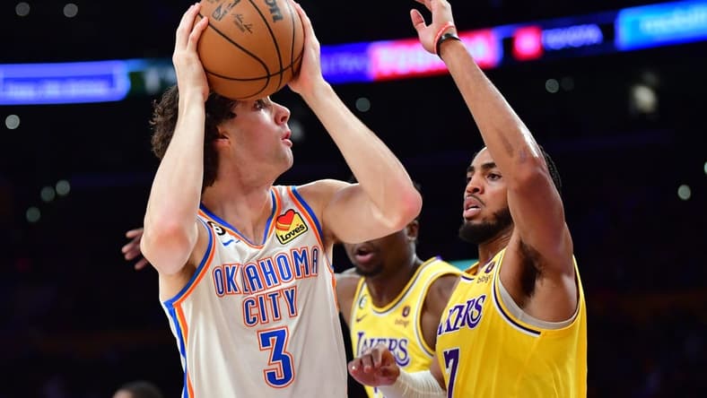 Feb 7, 2023; Los Angeles, California, USA; Oklahoma City Thunder guard Josh Giddey (3) shoots against Los Angeles Lakers forward Troy Brown Jr. (7) in the first half at Crypto.com Arena. Mandatory Credit: Gary A. Vasquez-USA TODAY Sports