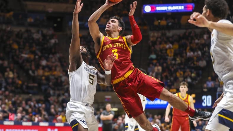 Feb 8, 2023; Morgantown, West Virginia, USA; Iowa State Cyclones guard Tamin Lipsey (3) shoots in the lane against West Virginia Mountaineers guard Joe Toussaint (5) during the first half at WVU Coliseum. Mandatory Credit: Ben Queen-USA TODAY Sports