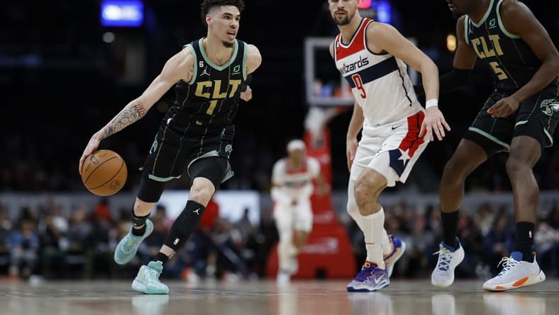 Feb 8, 2023; Washington, District of Columbia, USA; Charlotte Hornets guard LaMelo Ball (1) dribbles the ball as Washington Wizards forward Deni Avdija (9) defends in the second quarter at Capital One Arena. Mandatory Credit: Geoff Burke-USA TODAY Sports