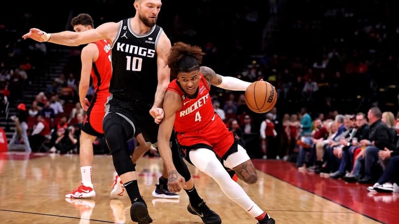 Feb 8, 2023; Houston, Texas, USA; Houston Rockets guard Jalen Green (4) handles the ball against Sacramento Kings forward Domantas Sabonis (10) during the first quarter at Toyota Center. Mandatory Credit: Erik Williams-USA TODAY Sports