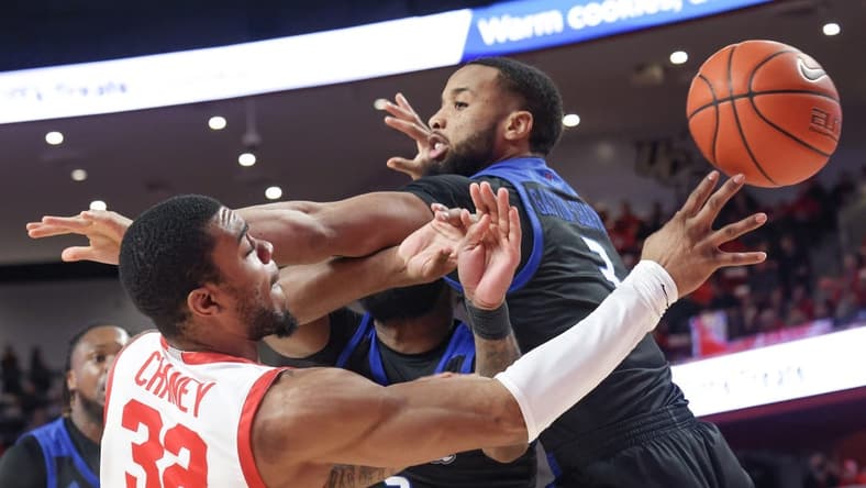 Feb 8, 2023; Houston, Texas, USA;Houston Cougars forward Reggie Chaney (32) passes against Tulsa Golden Hurricane guard Sterling Gaston-Chapman (3) in the first half at Fertitta Center. Mandatory Credit: Thomas Shea-USA TODAY Sports