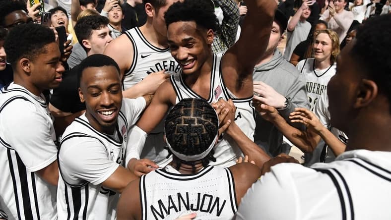 Feb 8, 2023; Nashville, Tennessee, USA; Vanderbilt Commodores guard Tyrin Lawrence (0) celebrates with teammates and fans after a win against the Tennessee Volunteers at Memorial Gymnasium. Mandatory Credit: Christopher Hanewinckel-USA TODAY Sports