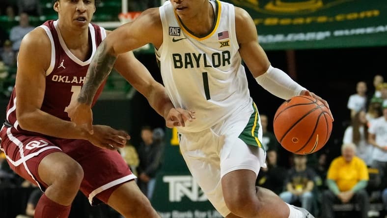 Feb 8, 2023; Waco, Texas, USA;  Baylor Bears guard Keyonte George (1) drives to the basket against Oklahoma Sooners forward Jalen Hill (1) during the first half at Ferrell Center. Mandatory Credit: Chris Jones-USA TODAY Sports