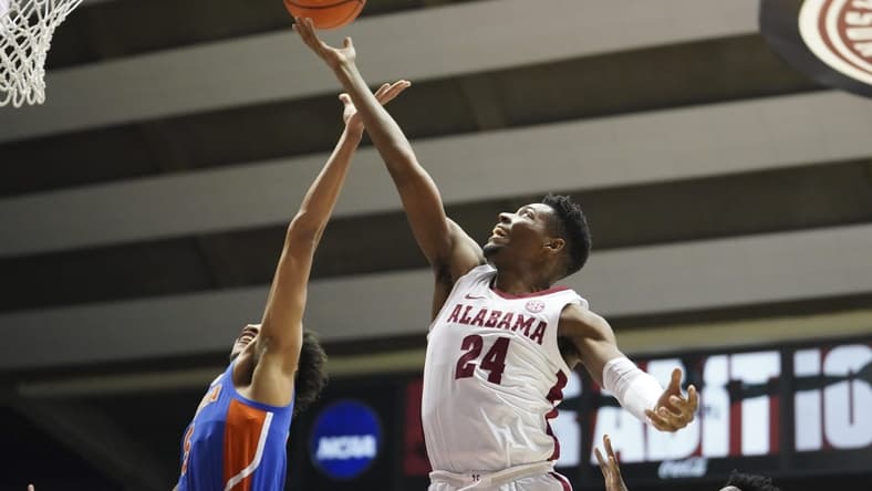 Feb 8, 2023; Tuscaloosa, Alabama, USA; Alabama Crimson Tide forward Brandon Miller (24) grabs a rebound against Florida Gators guard Will Richard (5) during the first half at Coleman Coliseum. Mandatory Credit: Marvin Gentry-USA TODAY Sports