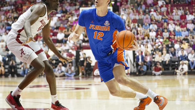 Feb 8, 2023; Tuscaloosa, Alabama, USA; Florida Gators forward Colin Castleton (12) looks to the basket against Alabama Crimson Tide center Charles Bediako (14) during the first half at Coleman Coliseum. Mandatory Credit: Marvin Gentry-USA TODAY Sports