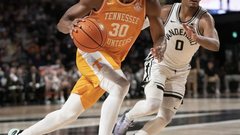 Feb 8, 2023; Nashville, Tennessee, USA; Tennessee Volunteers guard Josiah-Jordan James (30) drives past Vanderbilt Commodores guard Tyrin Lawrence (0) during the second half at Memorial Gymnasium. Vanderbilt defeated Tennessee 66 to 65. Mandatory Credit: George Walker IV - USA TODAY Sports