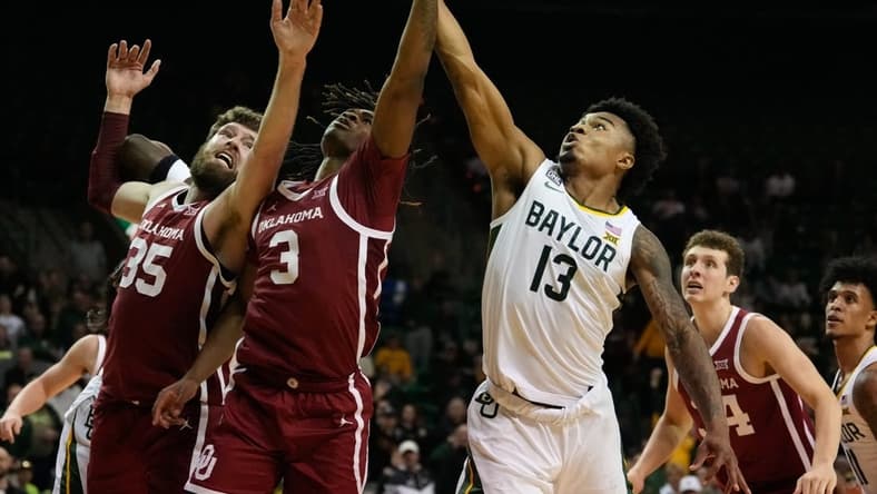 Feb 8, 2023; Waco, Texas, USA; Baylor Bears guard Langston Love (13) battles for a rebound against Oklahoma Sooners guard Otega Oweh (3) and forward Tanner Groves (35) during the second half at Ferrell Center. Mandatory Credit: Chris Jones-USA TODAY Sports
