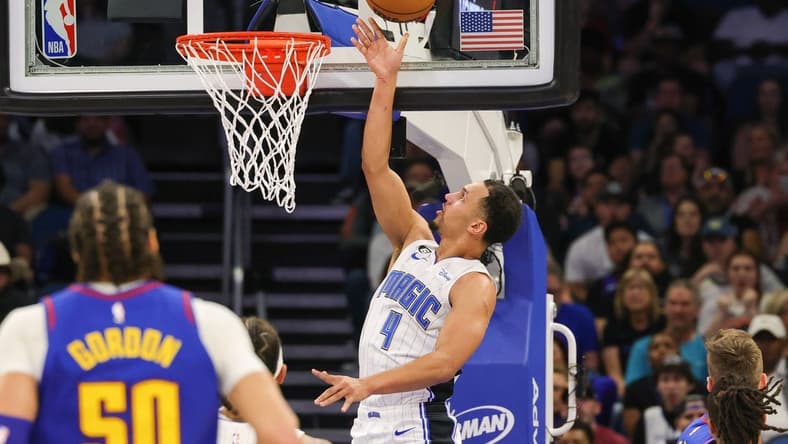 Feb 9, 2023; Orlando, Florida, USA; Orlando Magic guard Jalen Suggs (4) goes to the basket during the first quarter against the Denver Nuggets at Amway Center. Mandatory Credit: Mike Watters-USA TODAY Sports