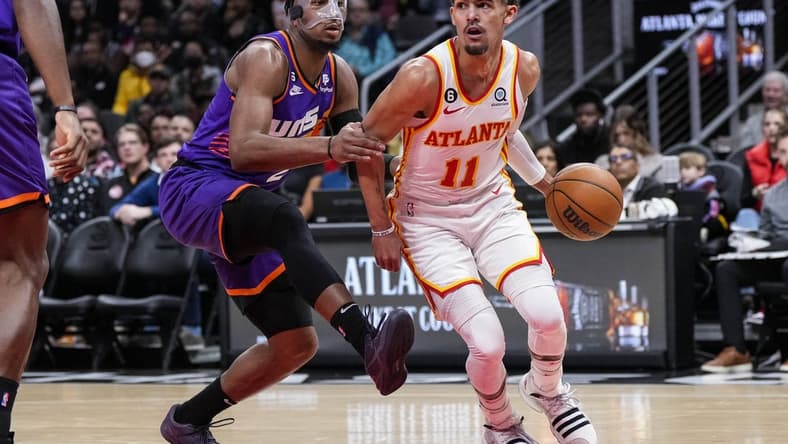 Feb 9, 2023; Atlanta, Georgia, USA; Atlanta Hawks guard Trae Young (11) works against Phoenix Suns forward Josh Okogie (2) during the first half at State Farm Arena. Mandatory Credit: Dale Zanine-USA TODAY Sports