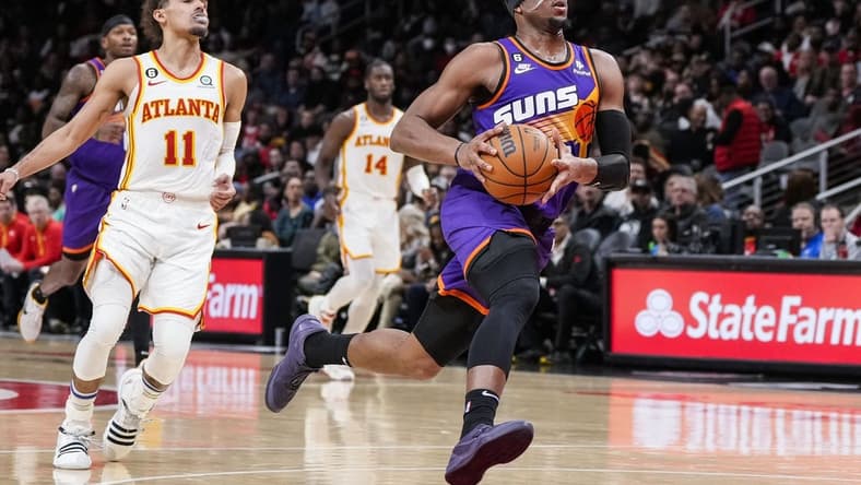 Feb 9, 2023; Atlanta, Georgia, USA; Phoenix Suns forward Josh Okogie (2) drives to the basket after a steal against Atlanta Hawks guard Trae Young (11) during the second half at State Farm Arena. Mandatory Credit: Dale Zanine-USA TODAY Sports