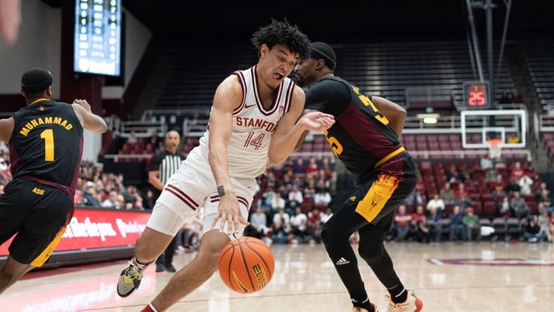 Feb 9, 2023; Stanford, California, USA; Stanford Cardinal forward Spencer Jones (14) drives the ball around Arizona State Sun Devils guard Devan Cambridge (35) during the first half at Maples Pavilion. Mandatory Credit: Stan Szeto-USA TODAY Sports