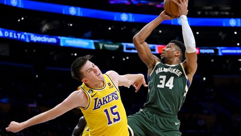 Feb 9, 2023; Los Angeles, California, USA; Los Angeles Lakers guard Austin Reaves (15) defends Milwaukee Bucks forward Giannis Antetokounmpo (34) as he drives to the basket in the first half at Crypto.com Arena. Mandatory Credit: Jayne Kamin-Oncea-USA TODAY Sports