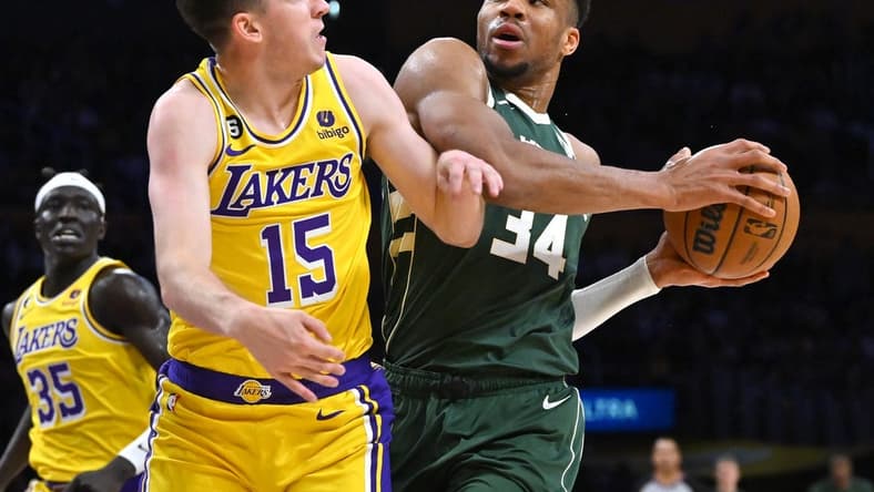 Feb 9, 2023; Los Angeles, California, USA;  Los Angeles Lakers guard Austin Reaves (15) defends Milwaukee Bucks forward Giannis Antetokounmpo (34) as he drives to the basket in the first half at Crypto.com Arena. Mandatory Credit: Jayne Kamin-Oncea-USA TODAY Sports