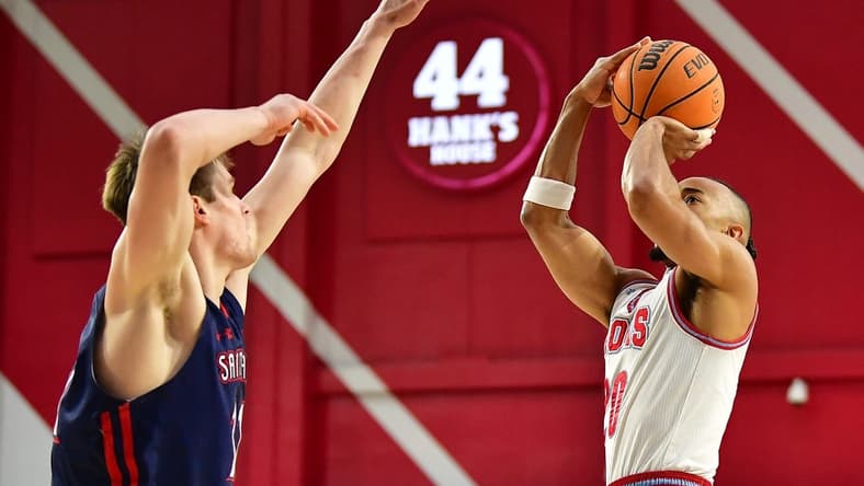 Feb 9, 2023; Los Angeles, California, USA; Loyola Marymount Lions guard Cam Shelton (20) shoots against St. Mary's Gaels center Mitchell Saxen (11) during the first half at Gersten Pavilion. Mandatory Credit: Gary A. Vasquez-USA TODAY Sports