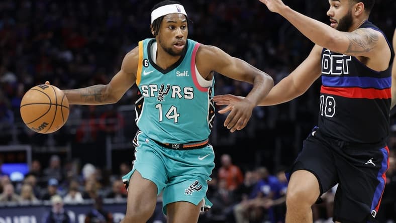 Feb 10, 2023; Detroit, Michigan, USA;  San Antonio Spurs guard Blake Wesley (14) dribbles on Detroit Pistons guard Cory Joseph (18) in the first half at Little Caesars Arena. Mandatory Credit: Rick Osentoski-USA TODAY Sports