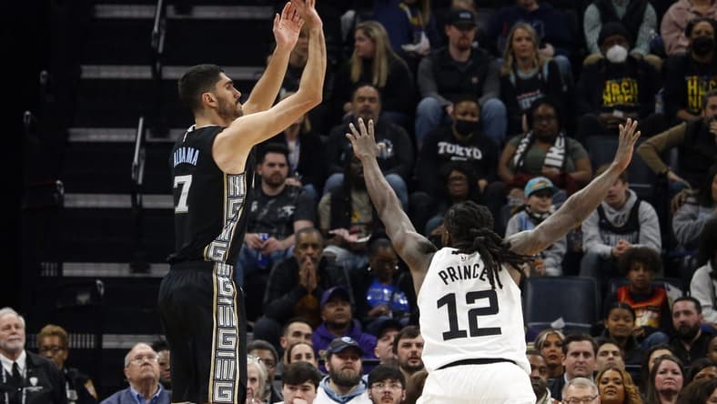 Feb 10, 2023; Memphis, Tennessee, USA; Memphis Grizzlies forward Santi Aldama (7) shoots for three as Minnesota Timberwolves forward Taurean Prince (12) defends during the first half at FedExForum. Mandatory Credit: Petre Thomas-USA TODAY Sports