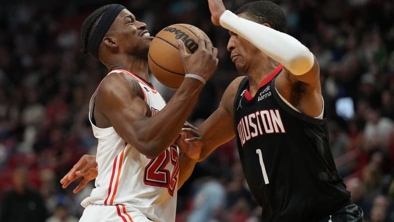 Feb 10, 2023; Miami, Florida, USA; Miami Heat forward Jimmy Butler (22) gets fouled by Houston Rockets forward Jabari Smith Jr. (1) in the first half at Miami-Dade Arena. Mandatory Credit: Jim Rassol-USA TODAY Sports