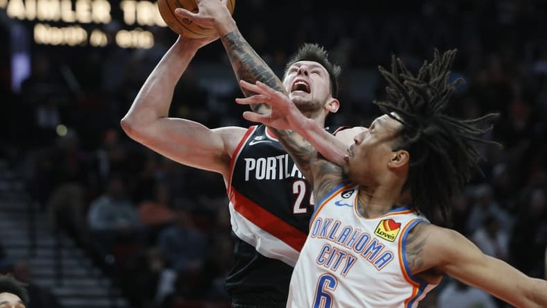 Feb 10, 2023; Portland, Oregon, USA; Portland Trail Blazers power forward Drew Eubanks (24) is fouled while shooting by Oklahoma City Thunder forward Jaylin Williams (6) during the first half at Moda Center. Mandatory Credit: Soobum Im-USA TODAY Sports