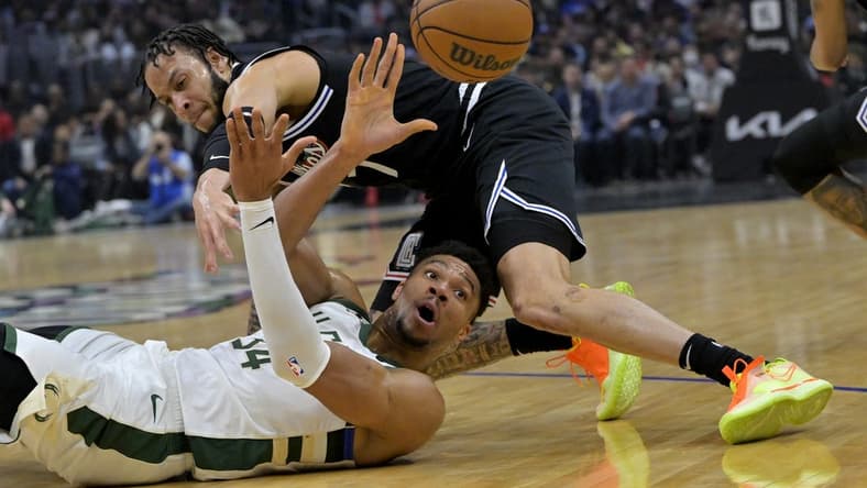 Feb 10, 2023; Los Angeles, California, USA;  Milwaukee Bucks forward Giannis Antetokounmpo (34) gains control of a loose ball and makes a pass as he is defended by Los Angeles Clippers guard Amir Coffey (7) in the first half at Crypto.com Arena. Mandatory Credit: Jayne Kamin-Oncea-USA TODAY Sports