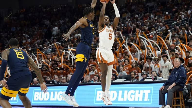 Feb 11, 2023; Austin, Texas, USA; Texas Longhorns guard Marcus Carr (5) shoots over West Virginia Mountaineers guard Kedrian Johnson (0) during the first half at Moody Center. Mandatory Credit: Scott Wachter-USA TODAY Sports ac