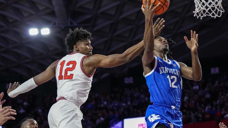 Feb 11, 2023; Athens, Georgia, USA; Kentucky Wildcats guard Antonio Reeves (12) goes to the basket behind Georgia Bulldogs forward Matthew-Alexander Moncrieffe (12) during the first half at Stegeman Coliseum. Mandatory Credit: Dale Zanine-USA TODAY Sports