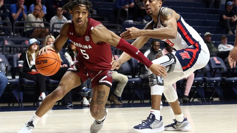 Feb 11, 2023; Oxford, Mississippi, USA; South Carolina Gamecocks guard Meechie Johnson (5) dribbles as Mississippi Rebels forward Robert Allen (21) defends during the first half at The Sandy and John Black Pavilion at Ole Miss. Mandatory Credit: Petre Thomas-USA TODAY Sports