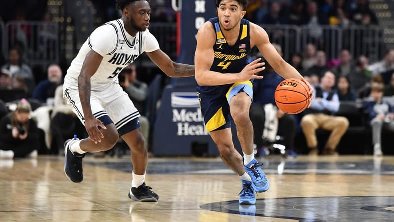 Feb 11, 2023; Washington, District of Columbia, USA; Marquette Golden Eagles guard Stevie Mitchell (4) dribbles as Georgetown Hoyas guard Jay Heath (5) defends during the second half at Capital One Arena. Mandatory Credit: Brad Mills-USA TODAY Sports