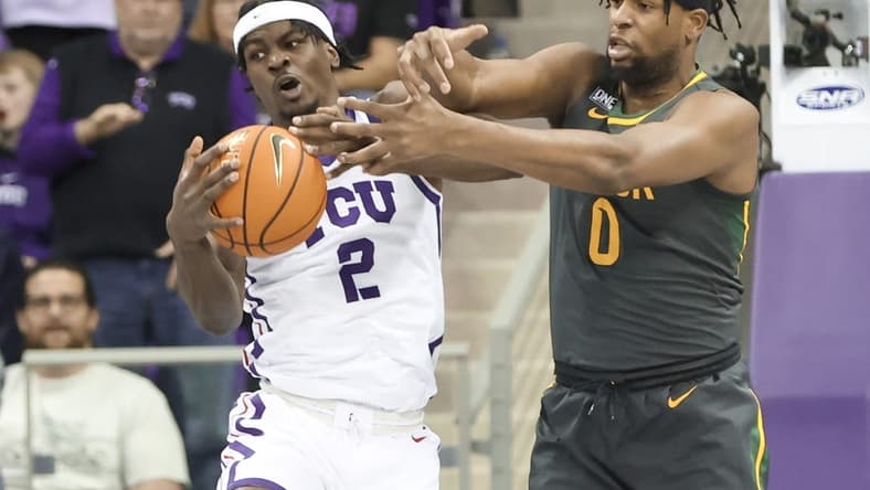 Feb 11, 2023; Fort Worth, Texas, USA; TCU Horned Frogs forward Emanuel Miller (2) and Baylor Bears forward Flo Thamba (0) go for the ball during the first half at Ed and Rae Schollmaier Arena. Mandatory Credit: Kevin Jairaj-USA TODAY Sports