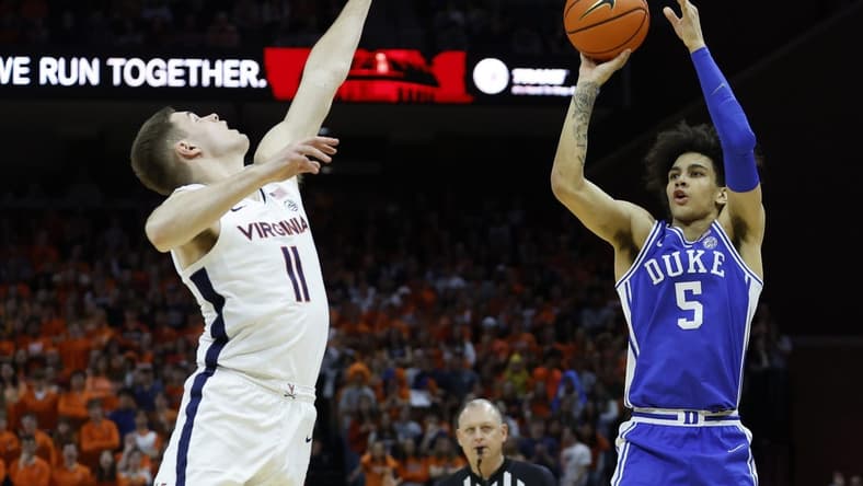 Feb 11, 2023; Charlottesville, Virginia, USA; Duke Blue Devils guard Tyrese Proctor (5) shoots the ball as Virginia Cavaliers guard Isaac McKneely (11) defends in the first half at John Paul Jones Arena. Mandatory Credit: Geoff Burke-USA TODAY Sports