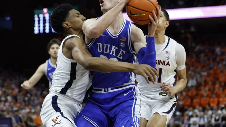 Feb 11, 2023; Charlottesville, Virginia, USA; Duke Blue Devils center Kyle Filipowski (30) drives to the basket as Virginia Cavaliers guard Ryan Dunn (13) defends in the first half at John Paul Jones Arena. Mandatory Credit: Geoff Burke-USA TODAY Sports
