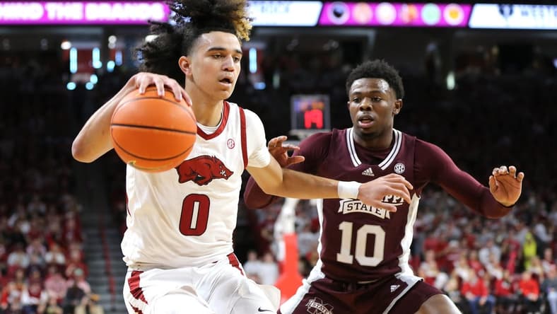 Feb 11, 2023; Fayetteville, Arkansas, USA; Arkansas Razorbacks guard Anthony Black (0) dribbles as Mississippi State Bulldogs guard Dashawn Davis (10) defends during the first half at Bud Walton Arena. Mandatory Credit: Nelson Chenault-USA TODAY Sports