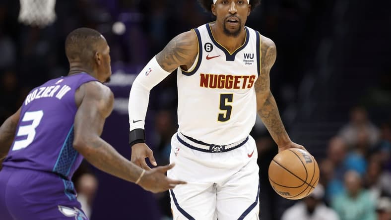Feb 11, 2023; Charlotte, North Carolina, USA; Denver Nuggets guard Kentavious Caldwell-Pope (5) controls the ball against Charlotte Hornets guard Terry Rozier (3) in the first quarter at Spectrum Center. Mandatory Credit: Brian Westerholt-USA TODAY Sports