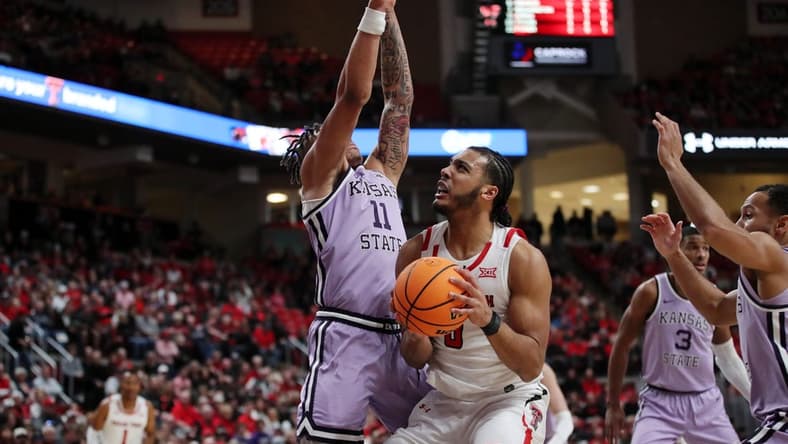 Feb 11, 2023; Lubbock, Texas, USA; Texas Tech Red Raiders forward Kevin Obanor (0) drives to the basket against Kansas State Wildcats forward Keyontae Johnson (11) in the first half at United Supermarkets Arena. Mandatory Credit: Michael C. Johnson-USA TODAY Sports