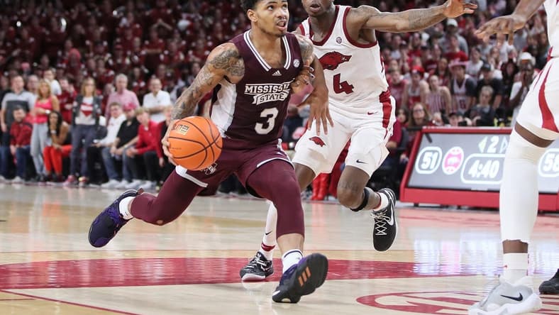 Feb 11, 2023; Fayetteville, Arkansas, USA; Mississippi State Bulldogs guard Shakeel Moore (3) dribbles in the lane against Arkansas Razorbacks guard Davonte Davis (4) during the first half at Bud Walton Arena. The Bulldogs won 70-64. Mandatory Credit: Nelson Chenault-USA TODAY Sports