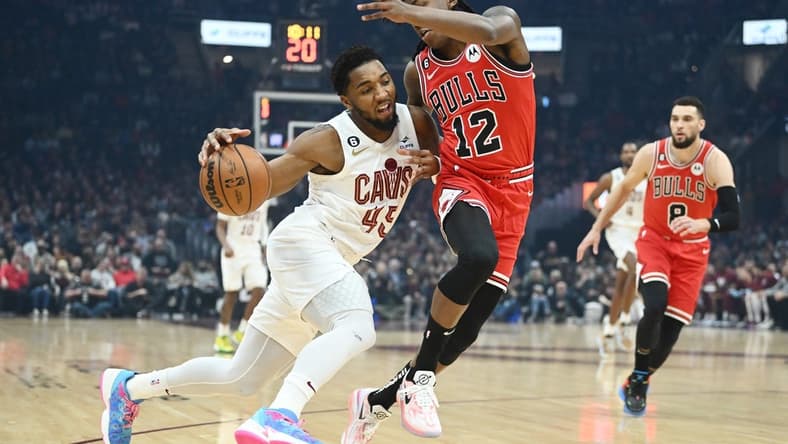 Feb 11, 2023; Cleveland, Ohio, USA; Cleveland Cavaliers guard Donovan Mitchell (45) drives to the basket against Chicago Bulls guard Ayo Dosunmu (12) during the first half at Rocket Mortgage FieldHouse. Mandatory Credit: Ken Blaze-USA TODAY Sports