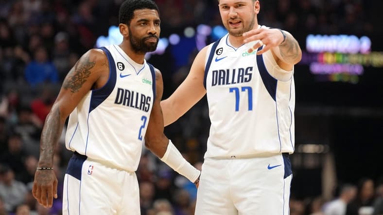 Feb 11, 2023; Sacramento, California, USA; Dallas Mavericks guard Kyrie Irving (2) and guard Luka Doncic (77) talk during the first quarter against the Sacramento Kings at Golden 1 Center. Mandatory Credit: Darren Yamashita-USA TODAY Sports