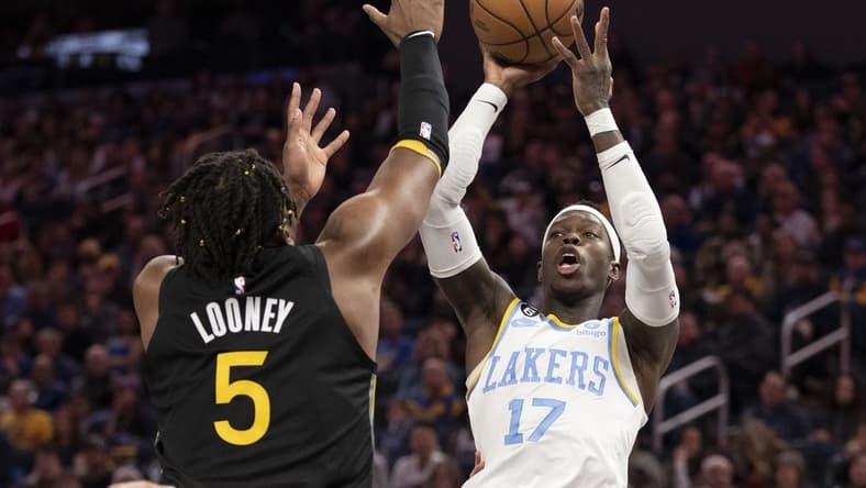 February 11, 2023; San Francisco, California, USA; Los Angeles Lakers guard Dennis Schroder (17) shoots the basketball against Golden State Warriors forward Kevon Looney (5) during the fourth quarter at Chase Center. Mandatory Credit: Kyle Terada-USA TODAY Sports
