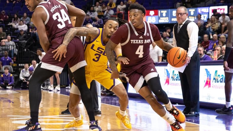 Feb 11, 2023; Baton Rouge, Louisiana, USA; Texas A&M Aggies guard Wade Taylor IV (4) dribbles the ball against LSU Tigers guard Justice Hill (3) during the second half at Pete Maravich Assembly Center. Mandatory Credit: Stephen Lew-USA TODAY Sports