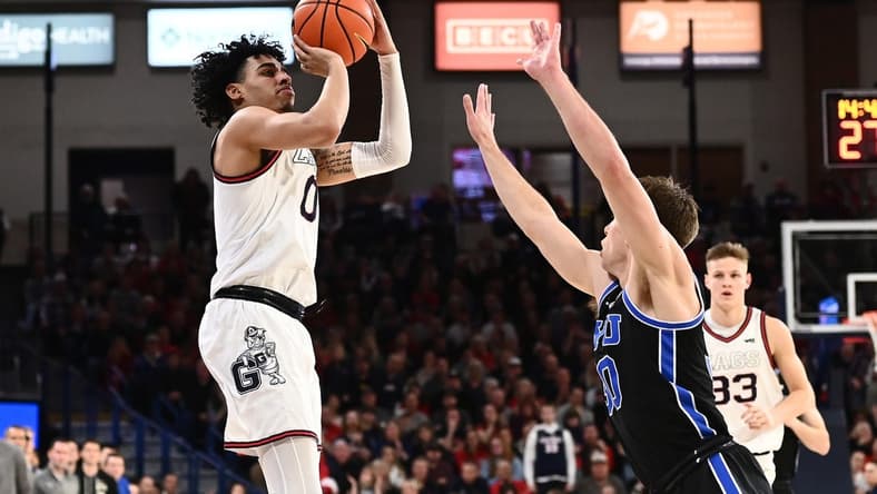 Feb 11, 2023; Spokane, Washington, USA; Gonzaga Bulldogs guard Julian Strawther (0) shoots the ball against Brigham Young Cougars guard Dallin Hall (30) in the second half at McCarthey Athletic Center. Gonzaga won 88-81. Mandatory Credit: James Snook-USA TODAY Sports