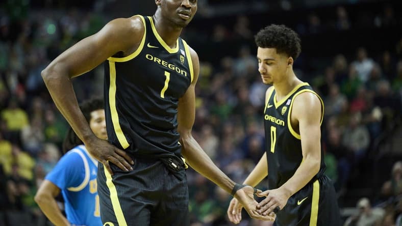 Feb 11, 2023; Eugene, Oregon, USA; Oregon Ducks center N'Faly Dante (1) gets a high five during the first half from teammate guard Will Richardson (0) at Matthew Knight Arena. Mandatory Credit: Troy Wayrynen-USA TODAY Sports
