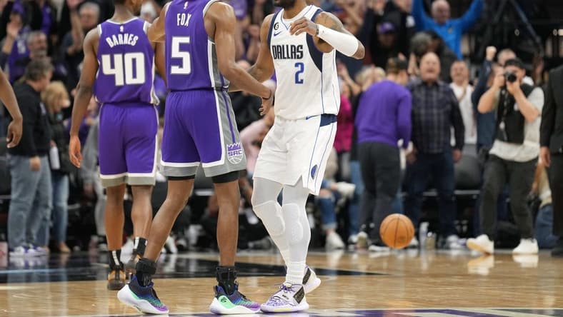 Feb 11, 2023; Sacramento, California, USA; Sacramento Kings guard De'Aaron Fox (5) and Dallas Mavericks guard Kyrie Irving (2) greet each other after the game at Golden 1 Center. Mandatory Credit: Darren Yamashita-USA TODAY Sports