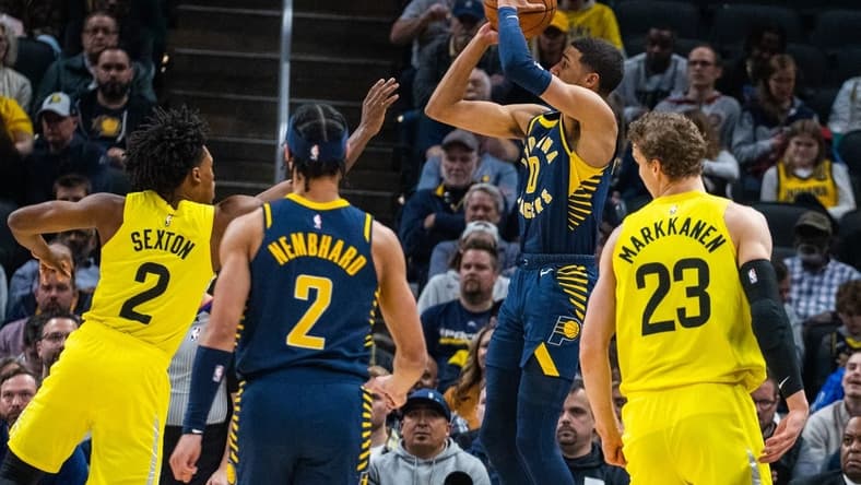 Feb 13, 2023; Indianapolis, Indiana, USA; Indiana Pacers guard Tyrese Haliburton (0) shoots the ball while Utah Jazz guard Collin Sexton (2) defends in the first quarter at Gainbridge Fieldhouse. Mandatory Credit: Trevor Ruszkowski-USA TODAY Sports